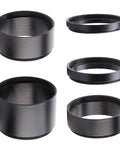 Five rings from the 2-Inch M48 Extension Tube Kit With 5 Rings For Backfocus, Eyepiece Projection And Flatteners shown at various angles.