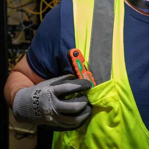 Person placing Compact Folding Hex Key Set With 25 Sizes in Metric and SAE Plus Torx Keys into safety vest pocket