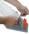 Hands adjusting a Heavy Duty Crown Molding Jig For Miter Saw Featuring Adjustable Fence for precise cuts on crown molding.