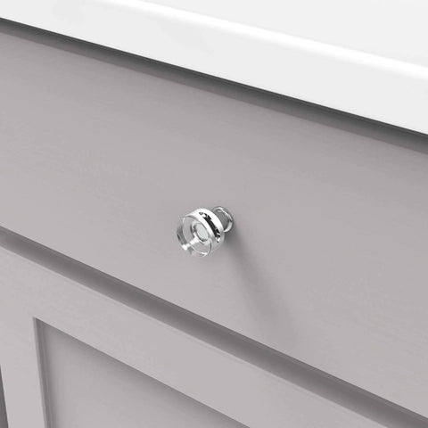 Solid Core Kitchen Cabinet Knobs In Crysacrylic With Chrome Finish 1 Inch Luxury Cabinet And Dresser Knobs Handles For Doors And Drawers Midway Collection By Hickory Hardware installed on a gray cabinet drawer.