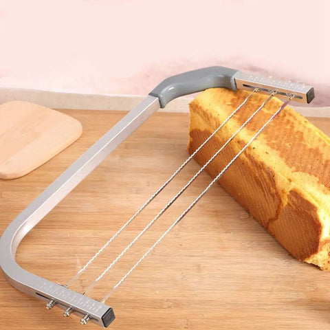 Adjustable Cake Leveler And Wire Slicer For Even Layer Cakes Pro Grade Stainless Steel Cutter slicing cake on wooden board