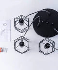 Industrial 3-Light Pendant Light With Black Metal Cage Shade viewed from above showing components and instructions
