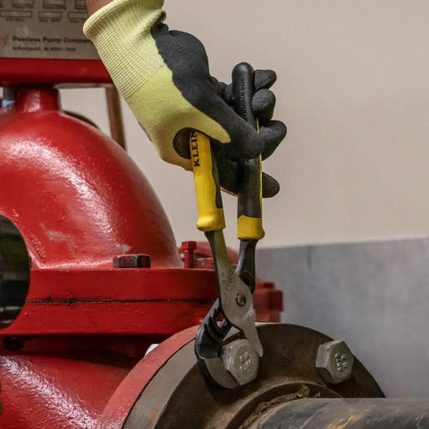 Using Adjustable Jaw Pump Pliers 10 Inch With Quick Adjust Rivet For One Hand Use on a metal pipe in an industrial setting
