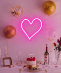 Pink Heart Neon Sign LED Light Up Wall Decor For Bedroom And Valentines Day Romance above a romantic dinner table