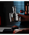 Top Shelf Espresso Needle Wdt Tool For 58mm Portafilter Black Coffee Ground Stirrer in use over ground coffee.