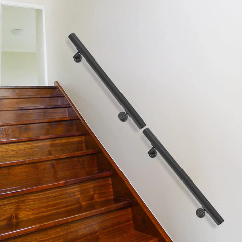 Rock Solid Wall Mounted Stair Handrail Crafted From Premium Black Stainless Steel features sleek cylindrical profile on wooden stairs.