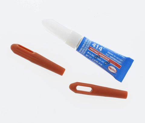 Bottle of Loctite 414 instant adhesive with two brown applicator caps.