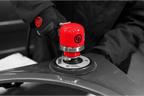Close-up of red 6 Inch Air Random Orbital Sander PSA Heavy Duty Dual Mode Rotary And Random Sanding on metal surface.