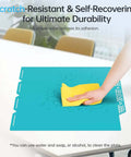 Cleaning the CryoGrip Pro Glacier Build Plate for Snapmaker U1 3D Printer with a yellow cloth, shows scratch-resistant surface.
