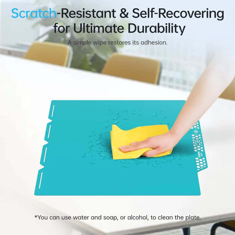 Cleaning the CryoGrip Pro Glacier Build Plate for Snapmaker U1 3D Printer with a yellow cloth, shows scratch-resistant surface.