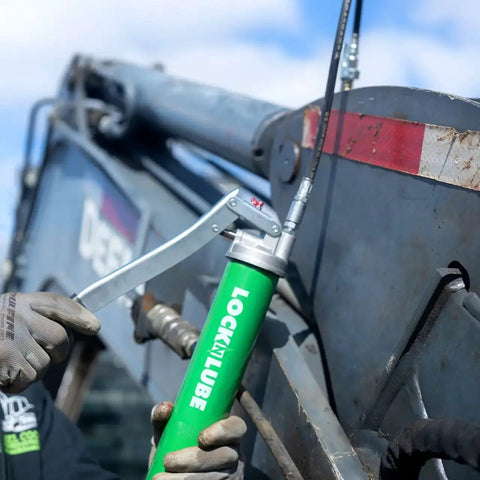 Lever Grip Grease Gun With Locking Coupler 20 Inch Heavy Duty Hose Inline Swivel in use on industrial machinery
