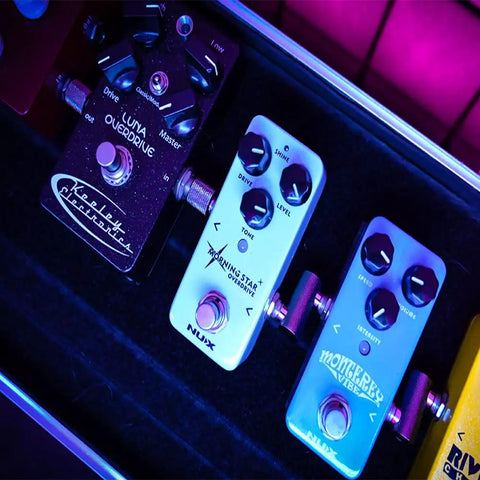 Guitar Pedal Patch Connectors One Quarter Inch Male To Male Four Pack With Two Straight And Two Z Type Angled Adapters in use on pedalboard