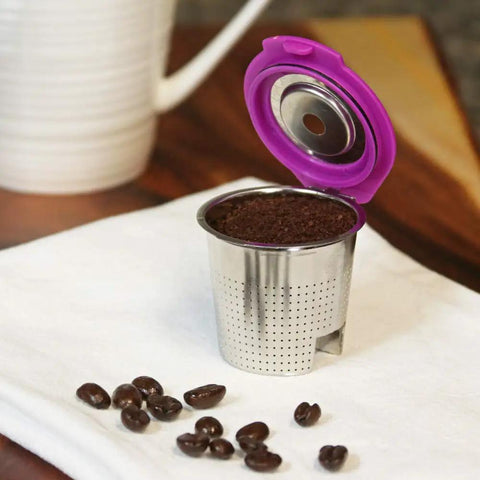 Stainless Steel Reusable K Cup 2 Pack With Built In Metal Filter For Keurig 1.0 2.0 KDuo KMini And More Eco Friendly Refillable Coffee Pod Delivers Rich Fresh Brew Every Time with open purple lid on white napkin