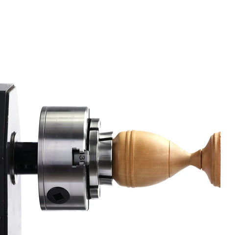 Beefy 3.75 Inch 4 Jaw Self Centering Scroll Chuck For Wood Lathe With 1 Inch 8 TPI Thread holding a wooden spindle in place