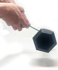 Hand holding Ultimate Hand Held Magnetic Pickup Tool For Gold Prospecting And Black Sand Separation With Five Strong Magnets To Filter Pay Dirt Fast And Isolate Gold From Concentrates Effortlessly In Your Panning Kit.