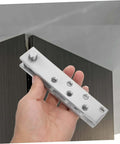 Hand holding 360 Degree Beefy Heavy Duty Concealed Door Hinges Stainless Steel Pivot System for Secret Doors.