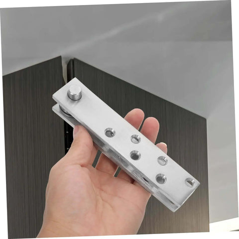 Hand holding 360 Degree Beefy Heavy Duty Concealed Door Hinges Stainless Steel Pivot System for Secret Doors.
