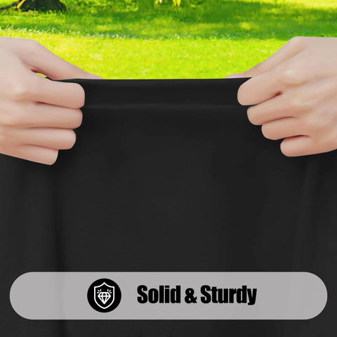 Close-up of hands pulling black picnic table cloth to show durability, 4 Pack Rectangle Picnic Table Cloths With Elastic Fitted Edges For A No Slip Waterproof And Spillproof Setup Washable Polyester Table Covers For Indoor Or Outdoor Use 30x72 Inches Black.