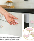 Decorative Pink Cloud Moon Star Cabinet Knobs Set, 6 Pack Zinc Alloy Knobs on white cabinet drawers being installed