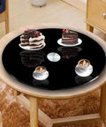 Heavy Duty 40 Inch Black Tempered GlassLazy Susan Turntable with desserts and coffees on a stylish table.