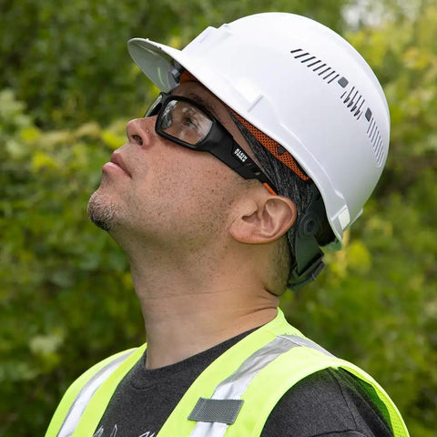 Person wearing Gasket Safety Glasses for Worksite PPE Eye Protection with full frame, foam gasket, and nylon strap outdoors.