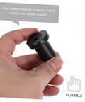 Hand holding a black carbon steel spacer from the 4 Piece Sliding Barn Door Track Spacers Replacement Carbon Steel Connector Hardware Kit.