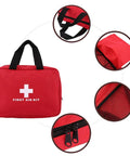 Front view of red empty first-aid kit bag with black handles, zipper, and mesh interior pocket