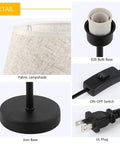 Detail view of Cozy Two Pack Space Saving Bedside Table Lamps, fabric shade, E26 bulb base, on-off switch, and iron base.
