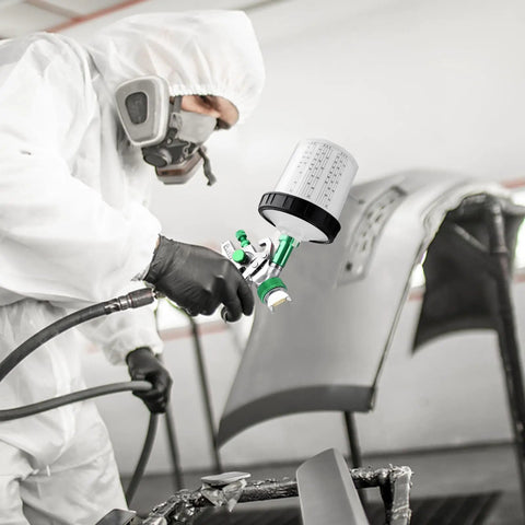 Painter using Paint Sprayer Kit With Quick Mixing Cup, HVLP Spray Gun, 1.4, 1.7, and 2.0mm Nozzles on car panel