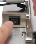 Finger pressing power switch of Top Shelf 3 In 1 Mini Belt Sander With 7 Speed Variable Control Bench Grinder.