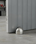 Heavy 2.2 Lb Stainless Steel Door Stop Wedge With Brushed Finish Floor Holder for hardwood and tile under gray door