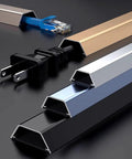 Wall Mounted Cable Raceway For Hidden Wires And Waterproof Cord Cover Keeps Cables Neat And Safe Baby Proof Ready For Home And Office 1 Meter Long By 30mm Wide Durable Wire Management Solution, close-up view with cords inside aluminium raceways of different colors.