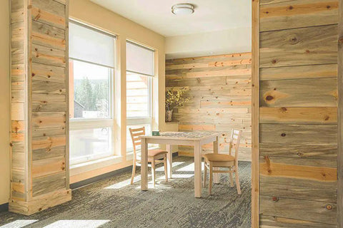 Bright room with wooden walls, table, and chairs near windows, not showing Flex Gray Vinyl Wall Base 4 Inch By 20 Foot With Peel And Stick Adhesive.