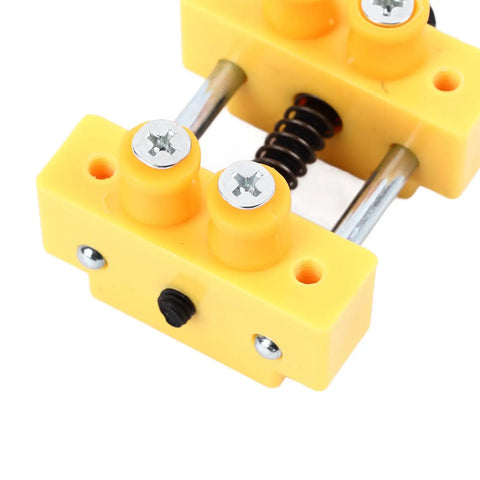 Close-up of Mini Table Vise Clamp Drill Press Jig for Small Projects with yellow base and metal screws