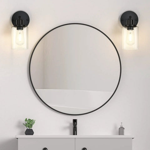 Black Wall Sconces Set Of Two With Clear Glass Shade on each side of a round mirror, 1-light design, bulbs not included