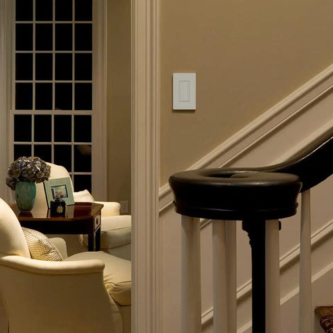 Living room corner with Maestro 8A Digital Light Switch For Single Pole And Multi Location, White Finish on wall next to stairs.