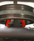 Harmonic Balancer Puller Kit for Cars and Trucks with Adjustable 3-Jaw Design in use on engine pulley.