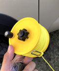 Hand holding Stiff UHMWPE Spearfishing Reel Line 175ft 1.9mm 680lb Load, Double Jacketed Shooting Line, yellow spool