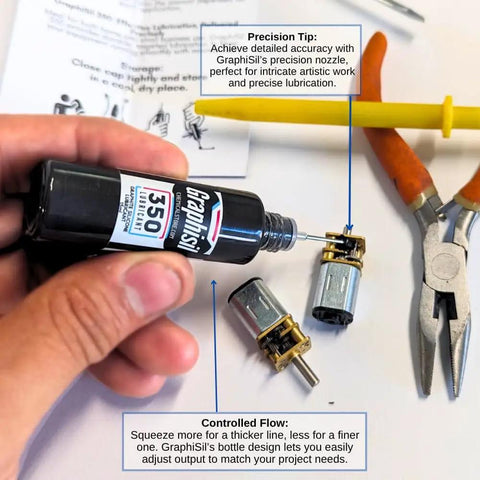 Hand holding a 15ml bottle labeled 'Graphisi 350 cSt', with precision nozzle near small gears and tools, on a workshop table.