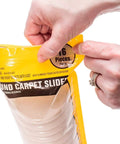 Hand opening package of Carpet Furniture Sliders Three Point Five Inch Round 16 Pack Make It A Breeze To Glide Heavy Sofas And Chairs