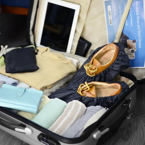 Reusable Boot And Shoe Covers For Real Estate Pros Water Resistant Non Skid And Washable To Keep Floors Carpets Footwear And Rooms Clean On The Job 2 Pairs Large Black inside a suitcase with folded clothes.