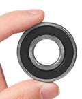 High Speed Deep Groove Ball Bearings Kit For Electric Vehicles Four Pack Rear Axle Bearings High Precision Energy Efficient Hubs And Motors Steel Build Reliable Performance For EV Powertrains Race Ready, sealed steel bearing in hand