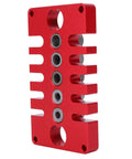 Red Punch Positioner Dowel Jig 3-In-1 Drill Guide Block for woodworking, shown from the side, with aluminum build and precise holes.