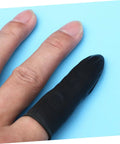 1000 Piece Black Latex Finger Sleeves Block Sneaky Sweat Smudges And Greasy Fingerprints From Messing With Pristine Hardware For Tough Shop Floor Crews And Weekend Gearheads Fixing Tight Builds on a finger against a blue background.