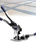 Hella Secure Manual Strapping Tool For Sealing Boxes And Cartons, handheld steel baler with handles on wooden surface.