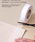 Easy No Sew Hemming Tape Fabric Adhesive DIY Friendly For Quick Hem Fixes On Pants Jeans Curtains And Dresses being cut