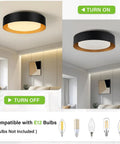 Black And Gold Flush Mount Ceiling Light With Glass Drum Shade Sixteen Point Five Inch Sleek Modern Round Fixture turned on and off in a minimalist living room.