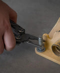 Using 13 In 1 Stainless Steel EDC Multitool With Nylon Sheath For Camping, Hiking, And Fishing on a bolt, close-up of pliers