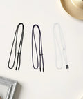 Ultimate 3pc Adjustable Drawstring Cord Kit For Hoodies And Suits Featuring Locking Toggle Stops End Caps Plus Round Poly Tool For Quick Sew Repair And Active Wear Fixes Without Tying. Three nylon cords with black, purple, and white toggles