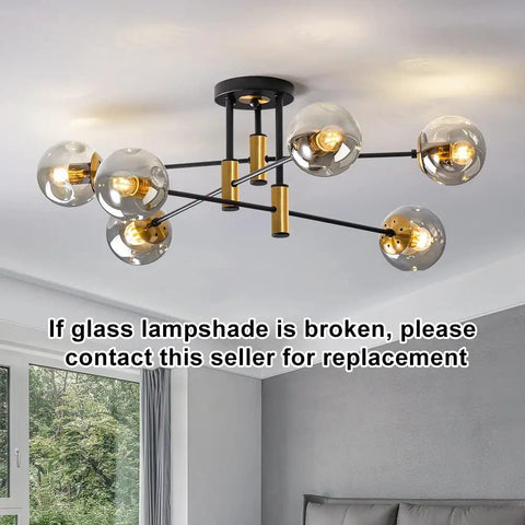 Six Light Sputnik Glass Globe Chandelier in Black and Gold Modern Mid Century Pendant Light in living room setting